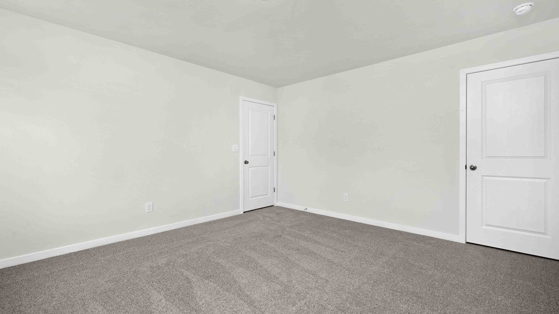 Carpeted bedroom with large windows