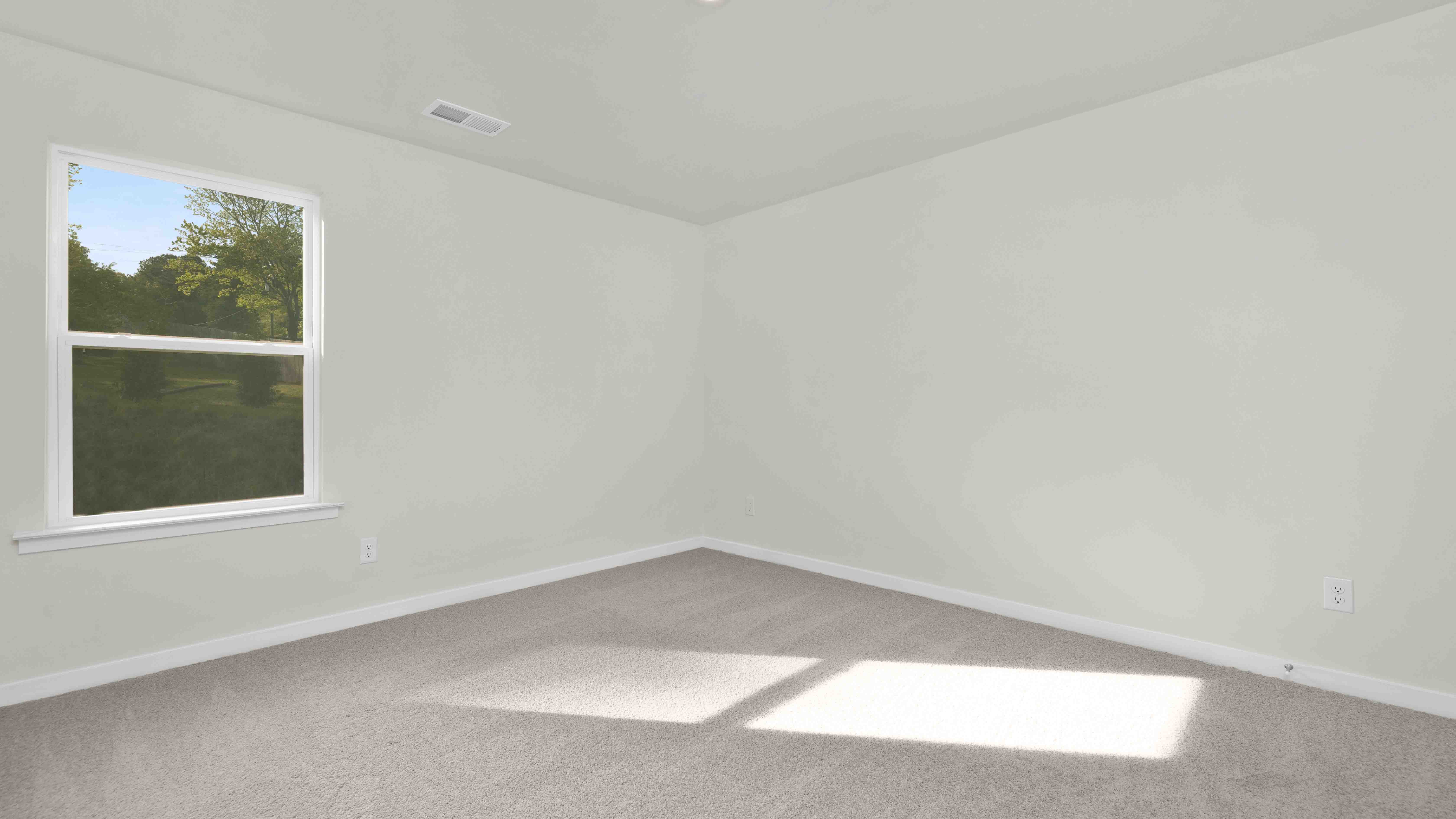 Carpeted bedroom with large windows