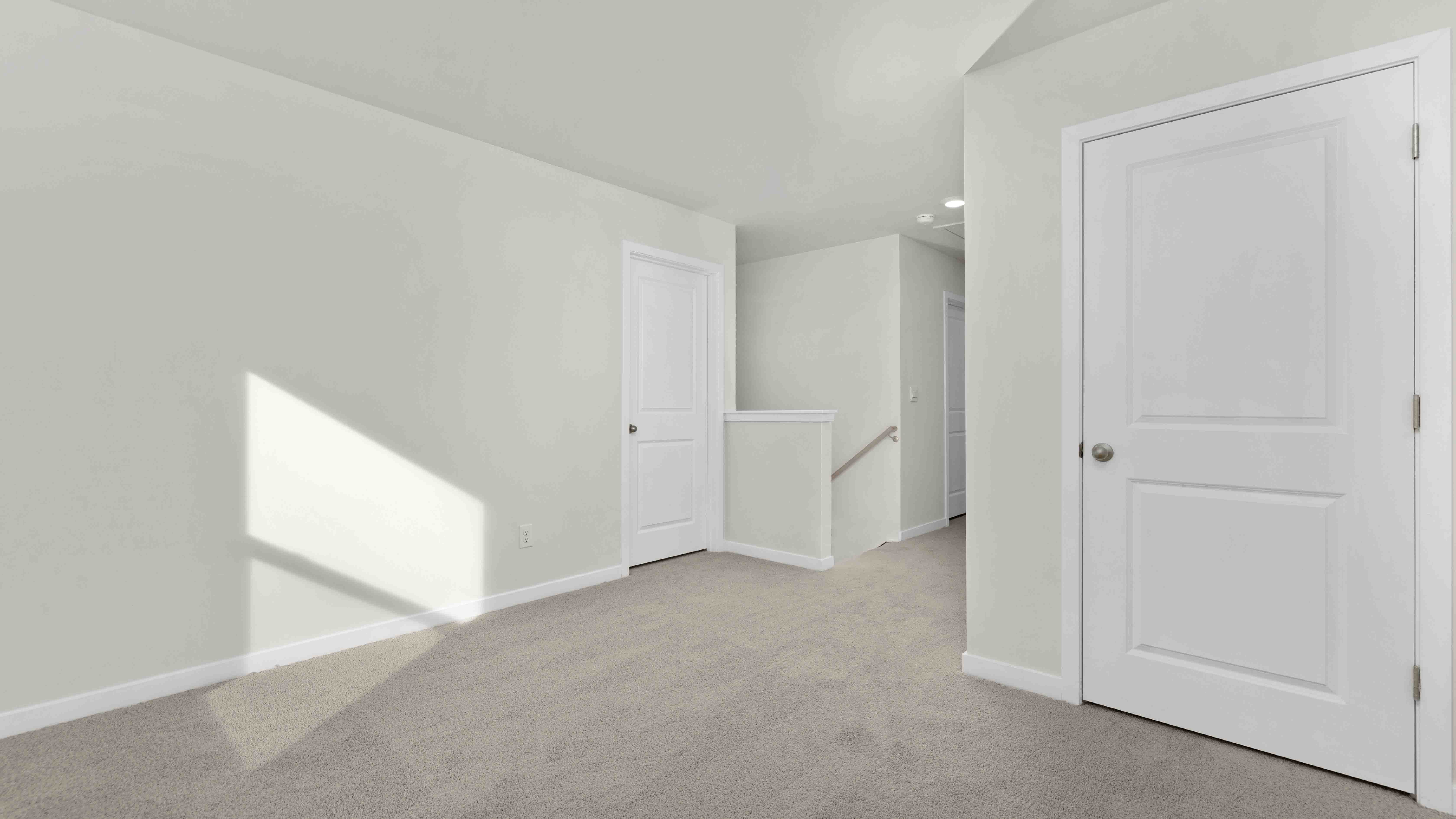 Carpeted bedroom with large windows