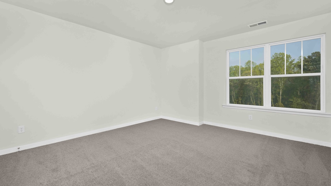 Carpeted bedroom with large windows