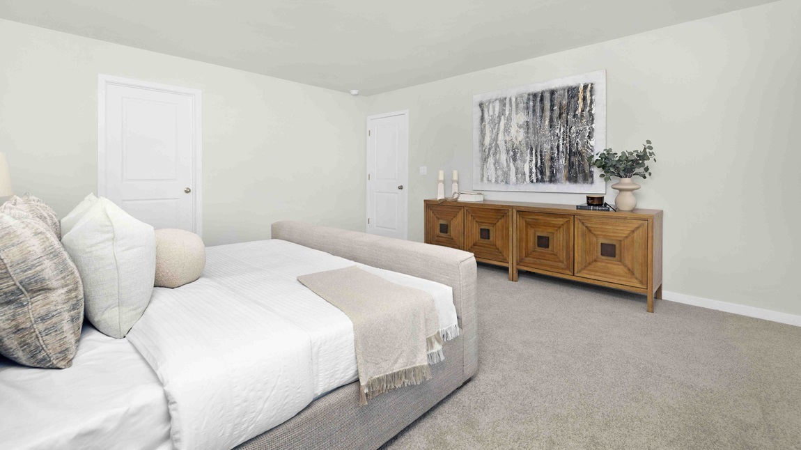 Carpeted bedroom with large windows
