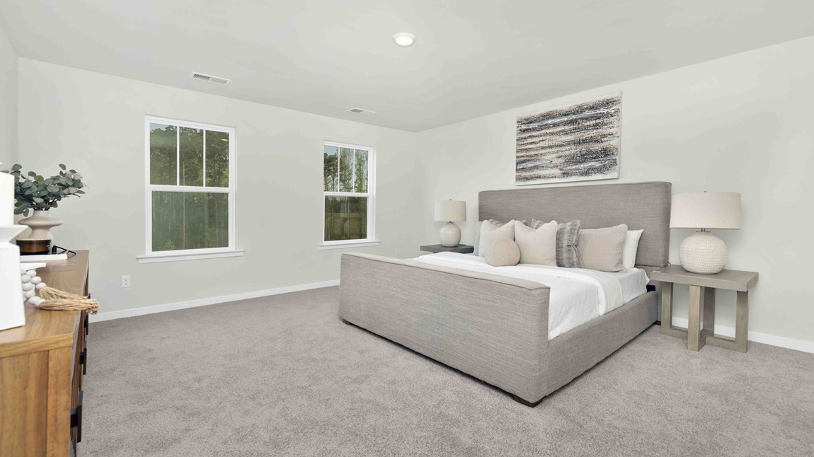 Carpeted bedroom with large windows