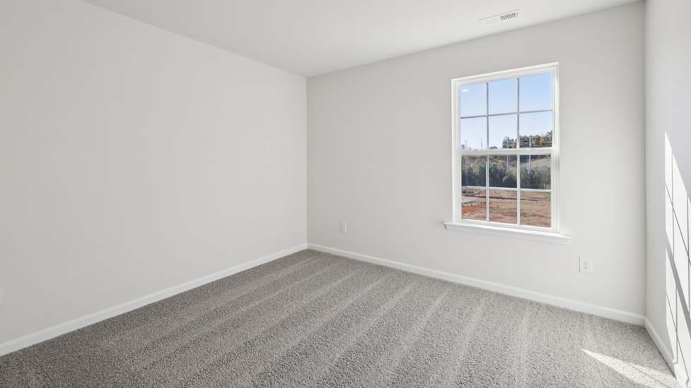 carpeted bedroom with small window