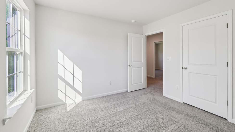 carpeted bedroom with small window