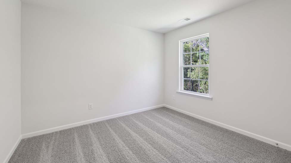 carpeted bedroom with small window