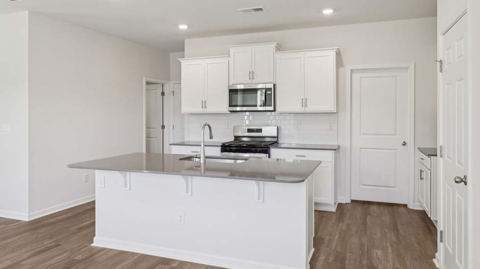 Kitchen and island with stainless steel appliances