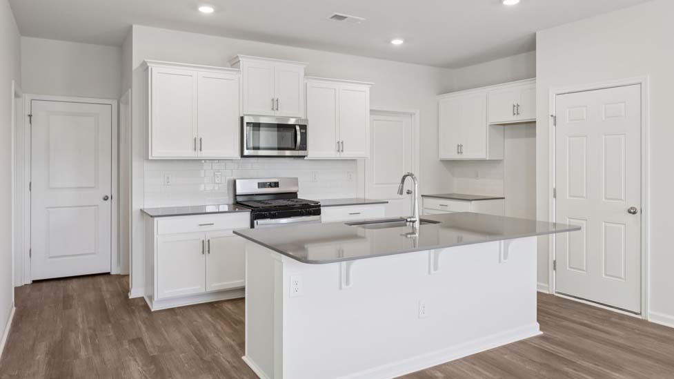 Kitchen and island with stainless steel appliances