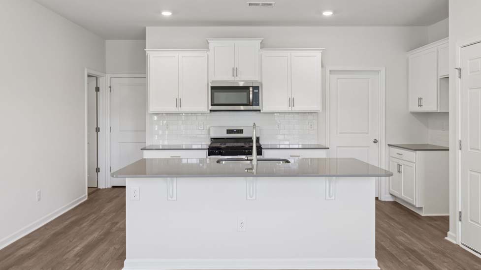 Kitchen and island with stainless steel appliances