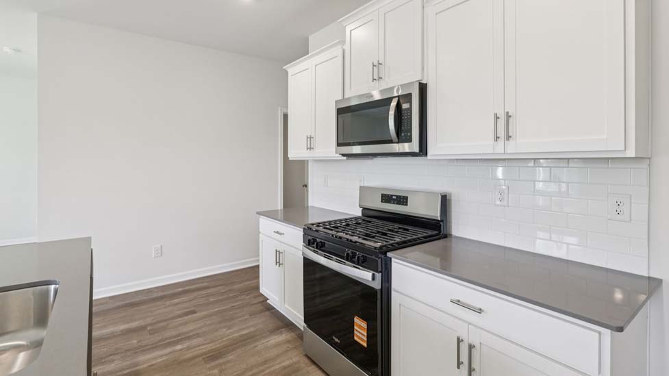 Kitchen and island with stainless steel appliances