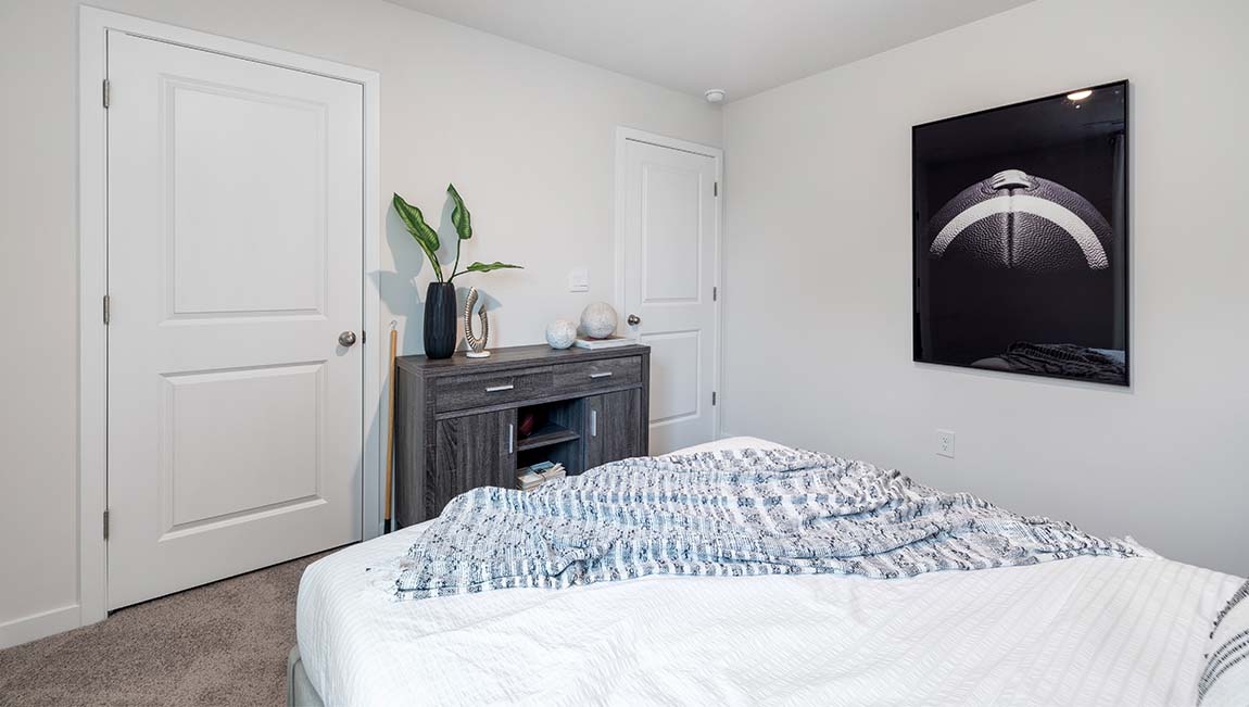 Carpeted primary bedroom with large window
