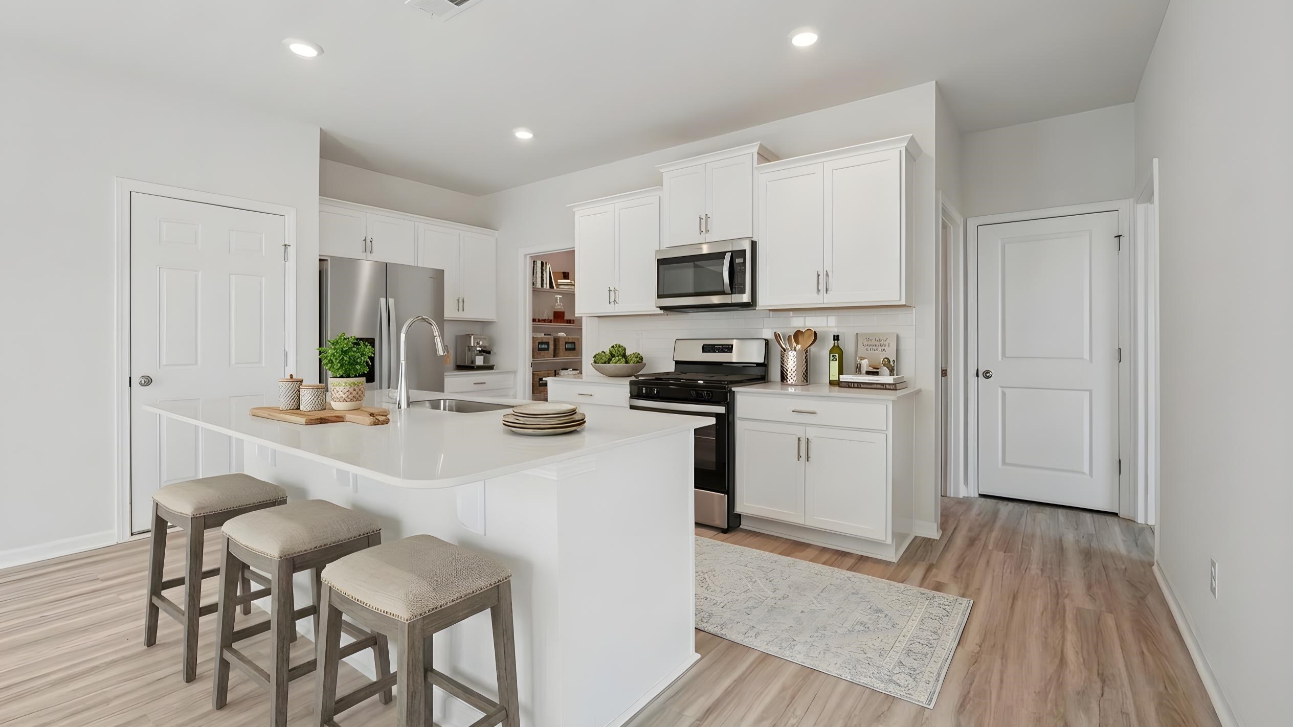 Kitchen and island with stainless steel appliances