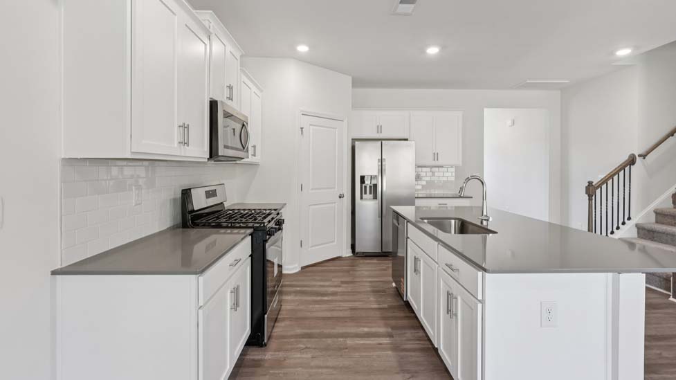 kitchen and island with stainless steel appliances