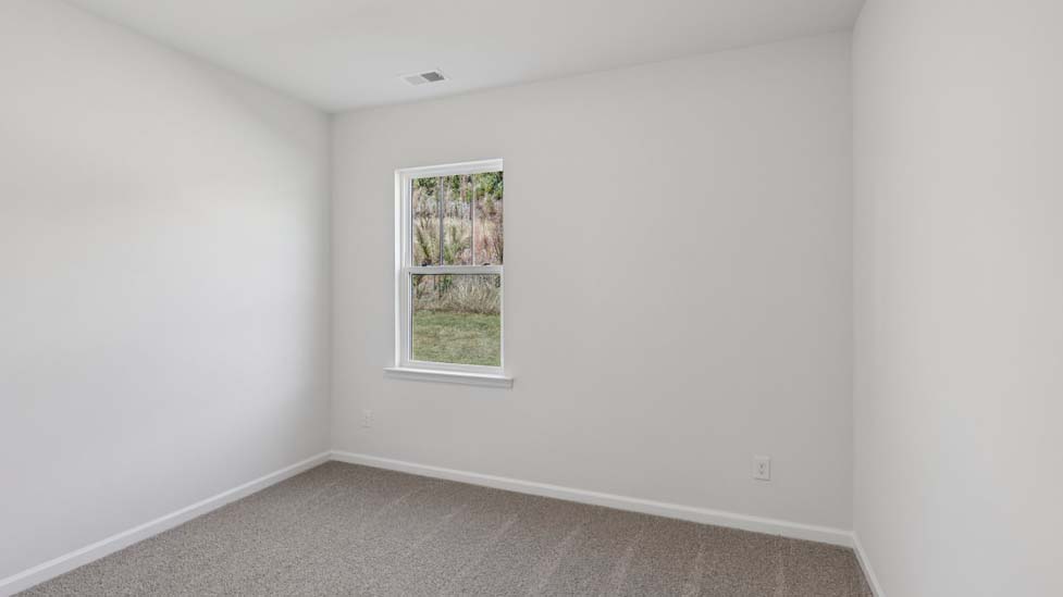 Carpeted bedroom with small window
