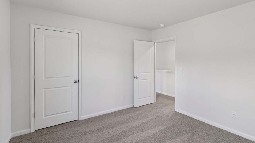Carpeted bedroom with small window