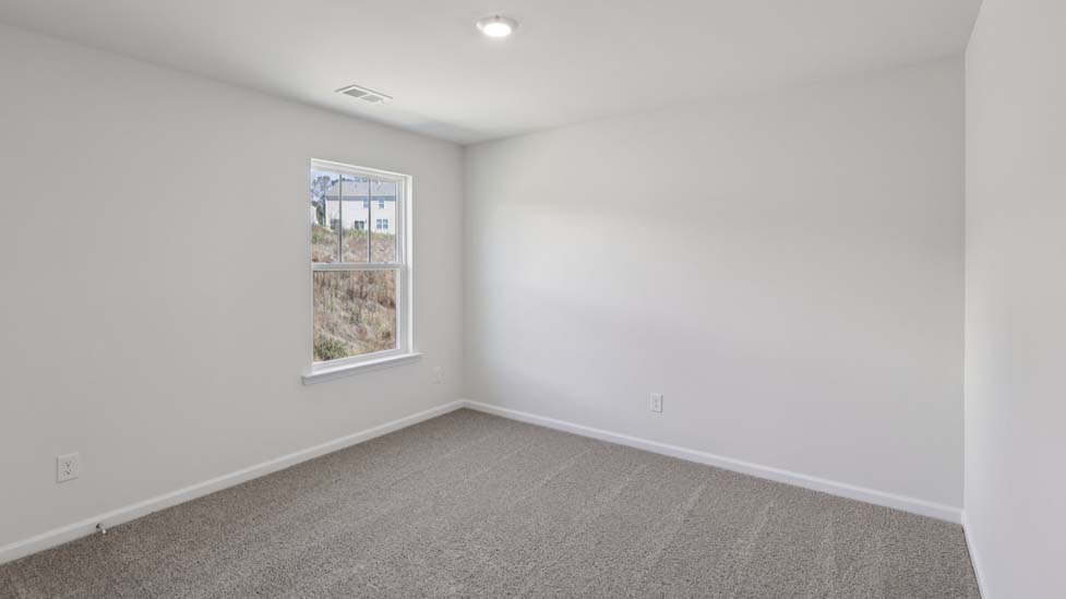 Carpeted bedroom with small window