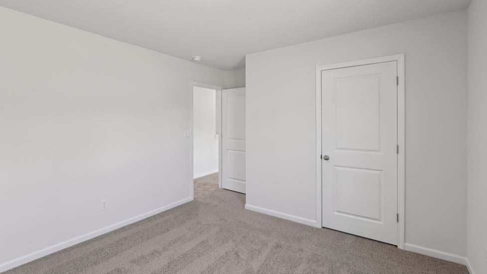 Carpeted bedroom with small window