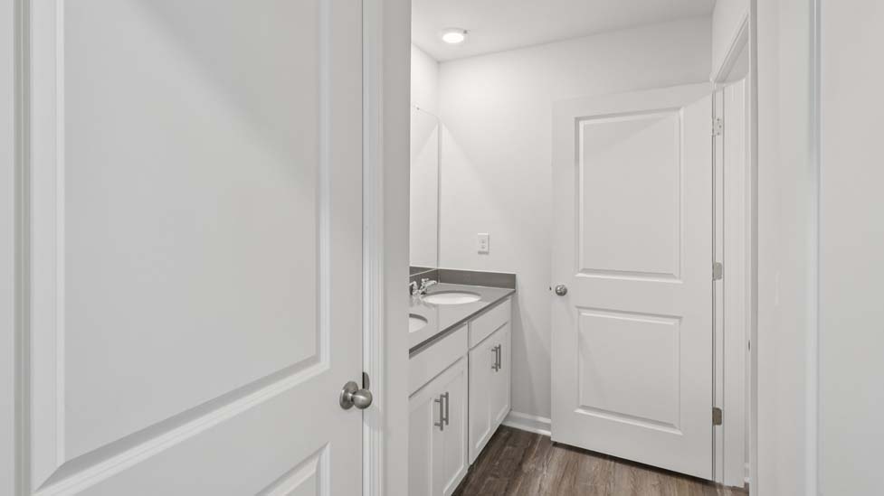 Bathroom with doubke sink vanity and bathtub shower combo