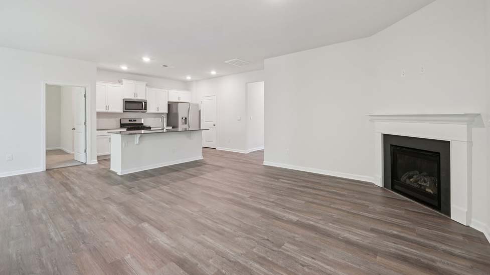 Open concept living roo with fireplace and large windows