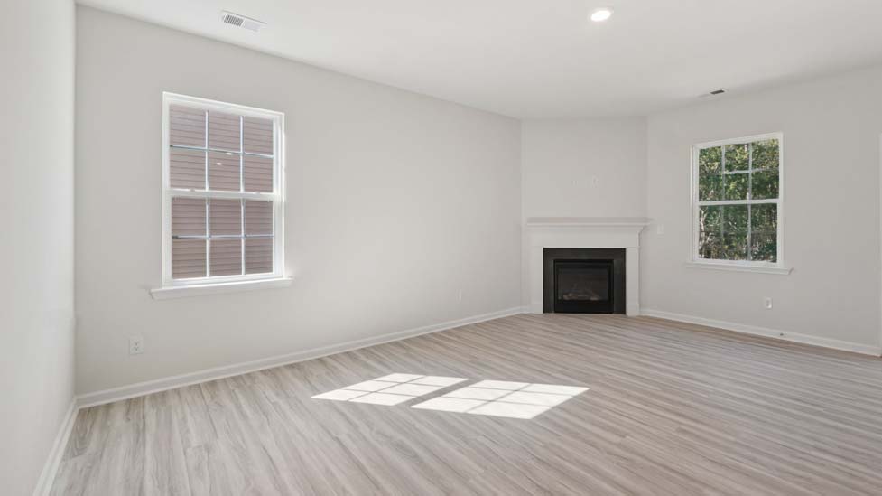 Open concept living roo with fireplace and large windows