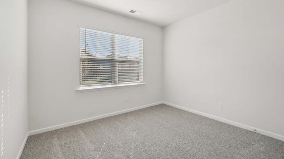 carpeted bedroom with large window