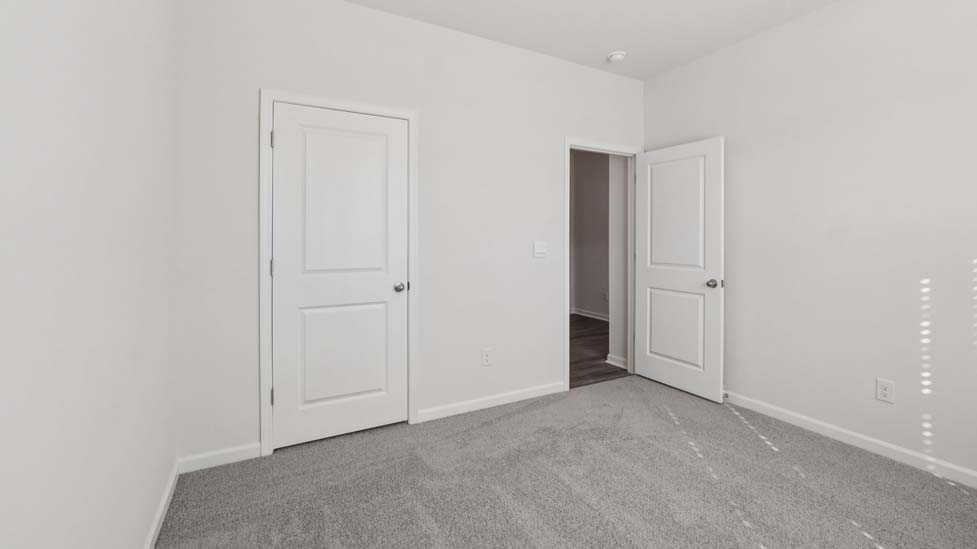 carpeted bedroom with large window