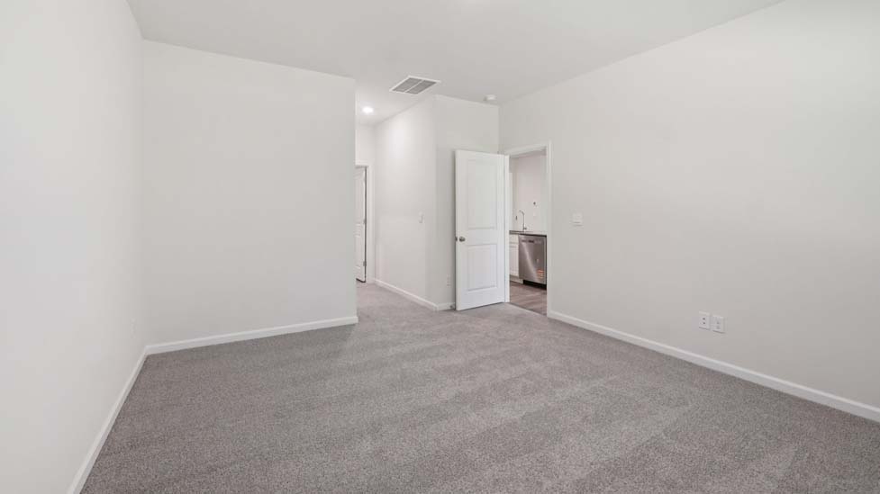 carpeted bedroom with large window