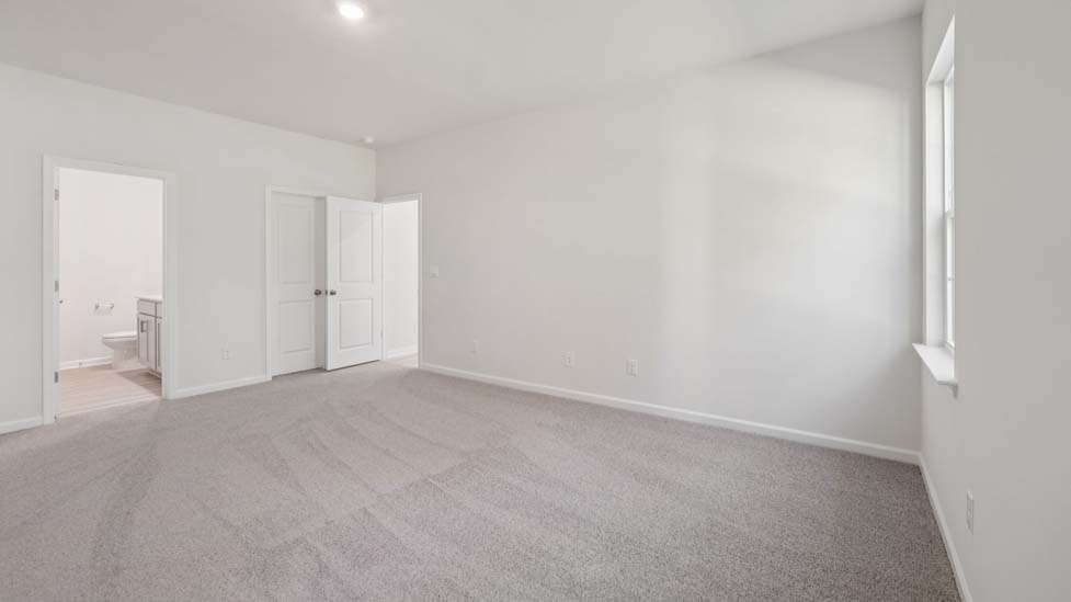 carpeted bedroom with large window