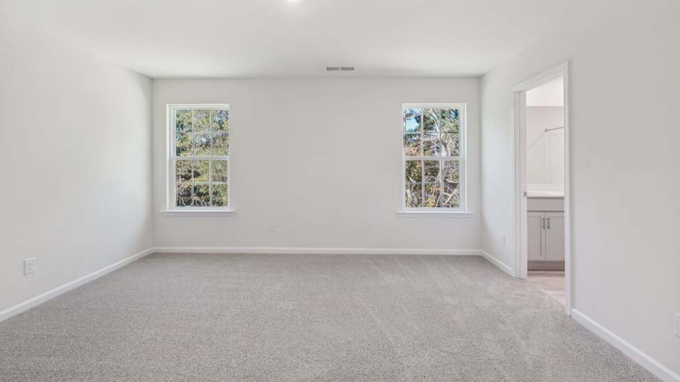 carpeted bedroom with large window