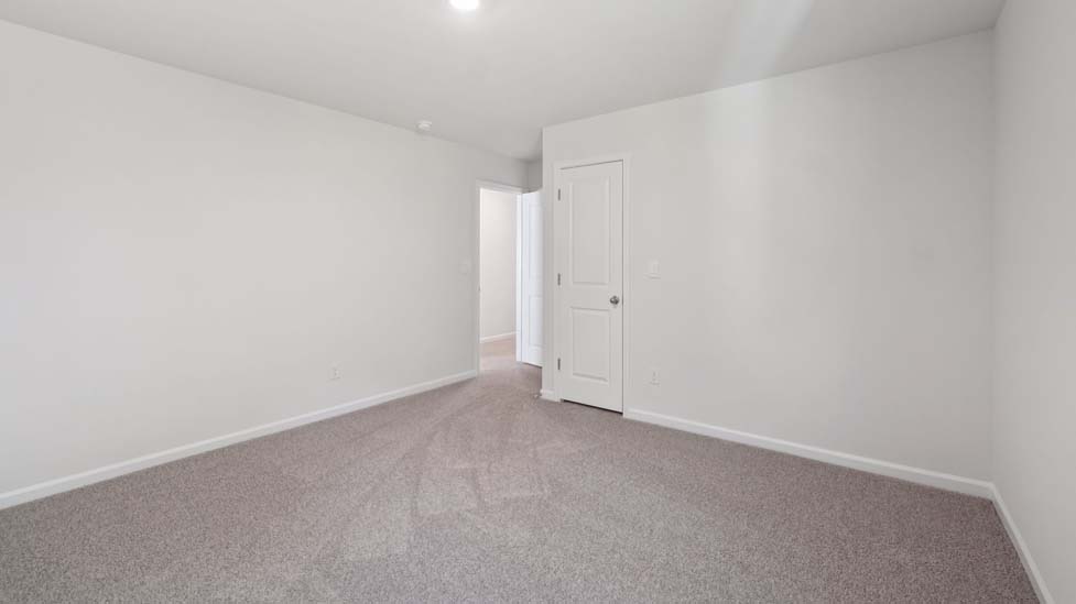 carpeted bedroom with large window