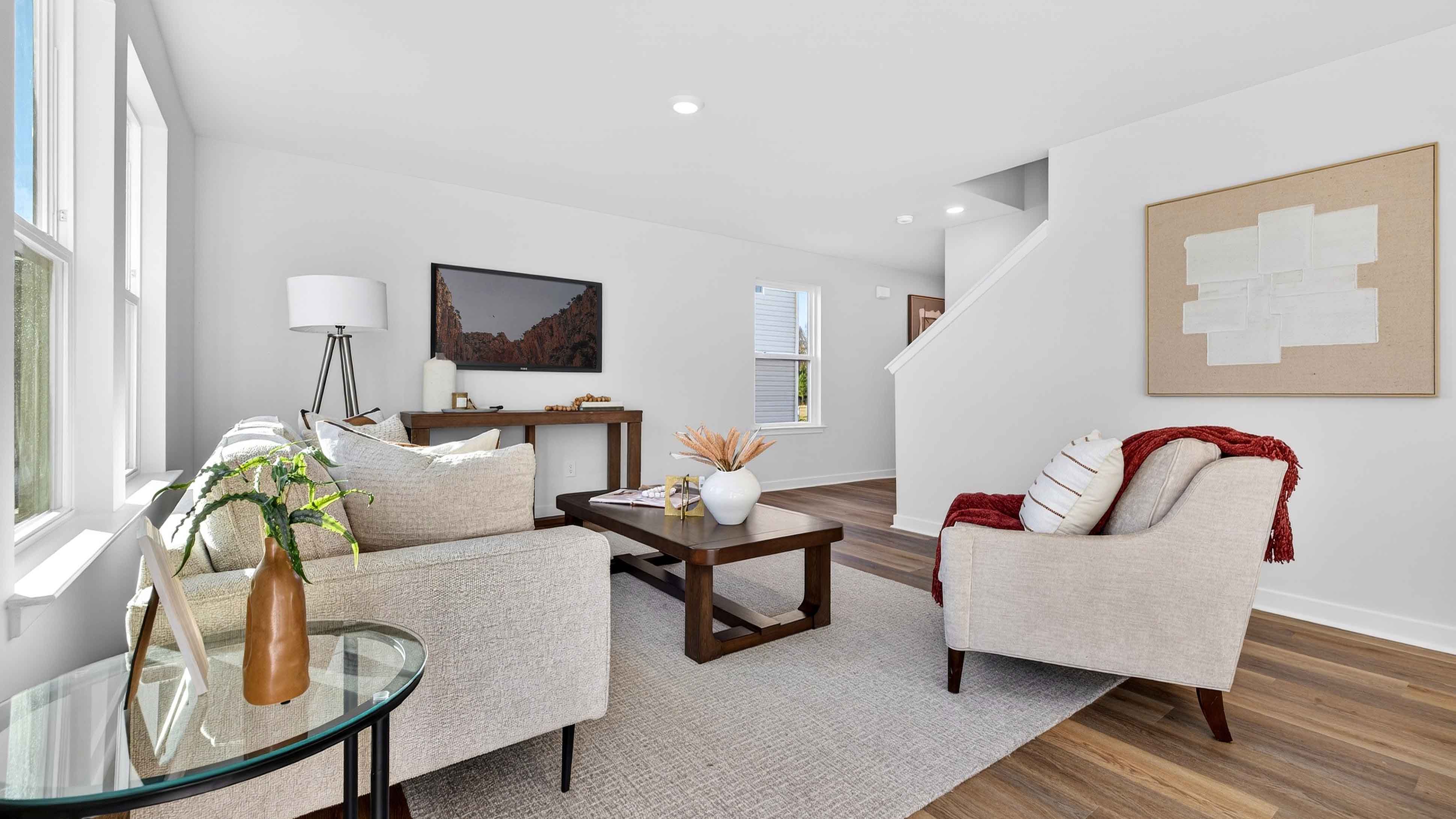 Open living room by kitchen and stairs