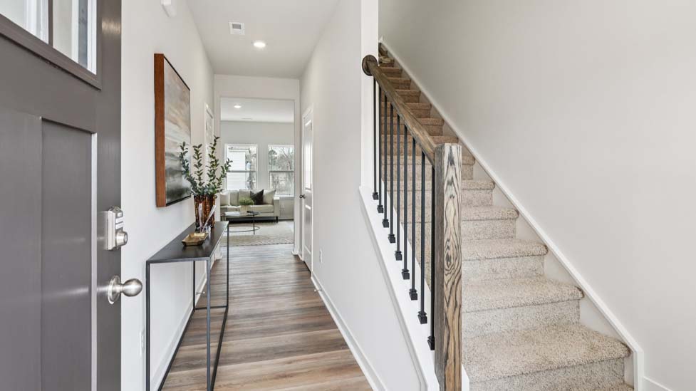 Welcoming foyer with wood floors, view of front door
