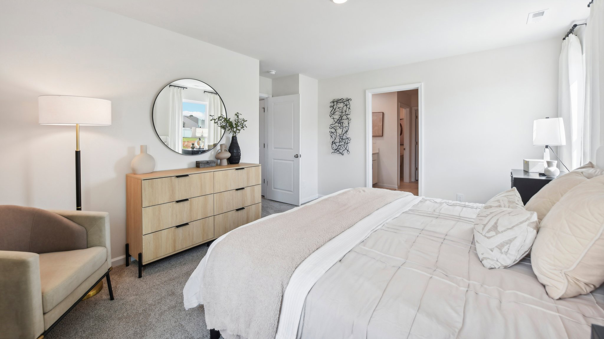 Primary bedroom with carpet and two large windows