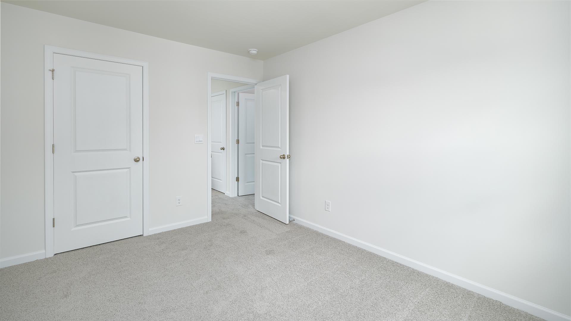 Carpeted bedroom with small window