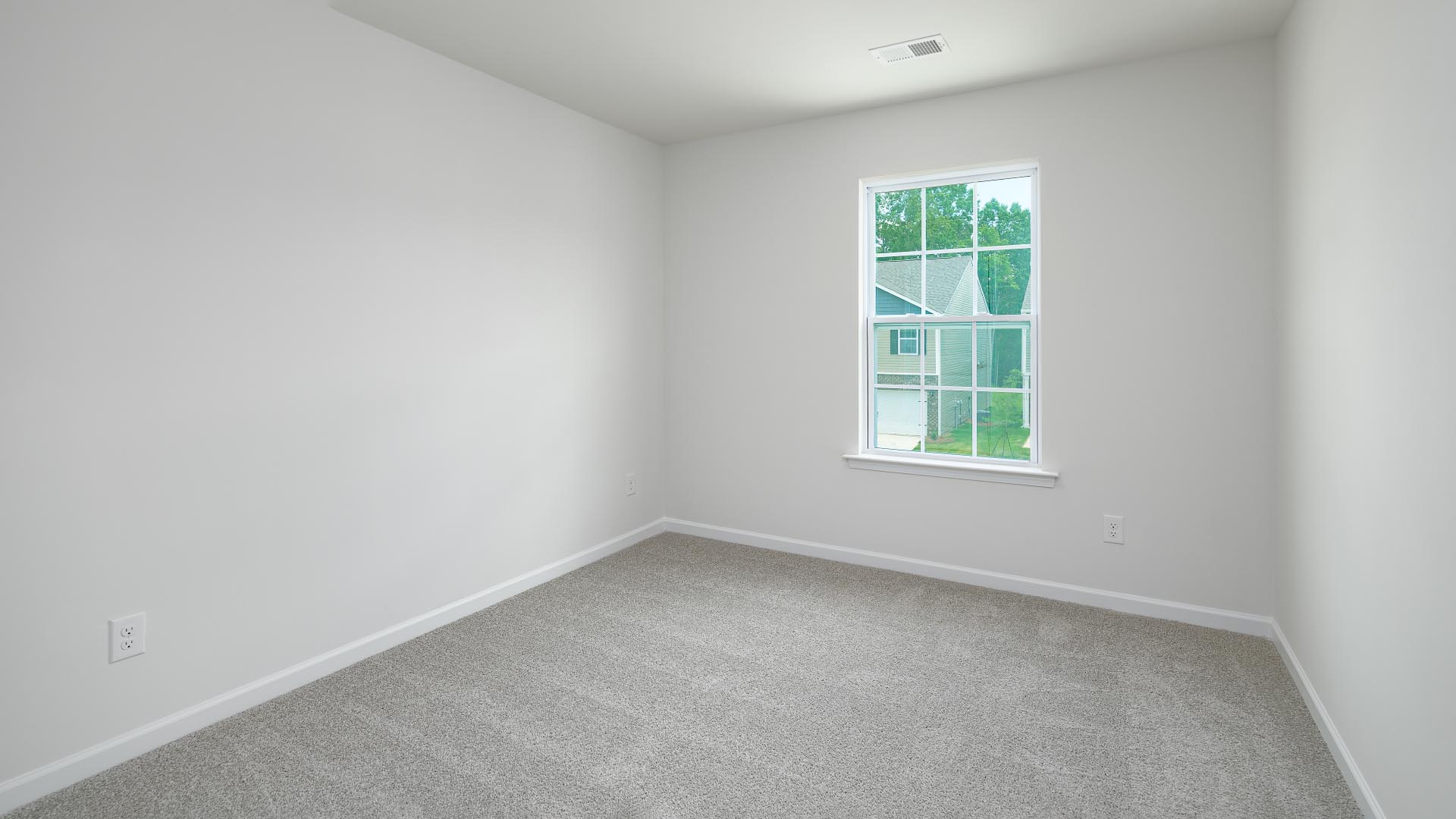 Carpeted bedroom with small window