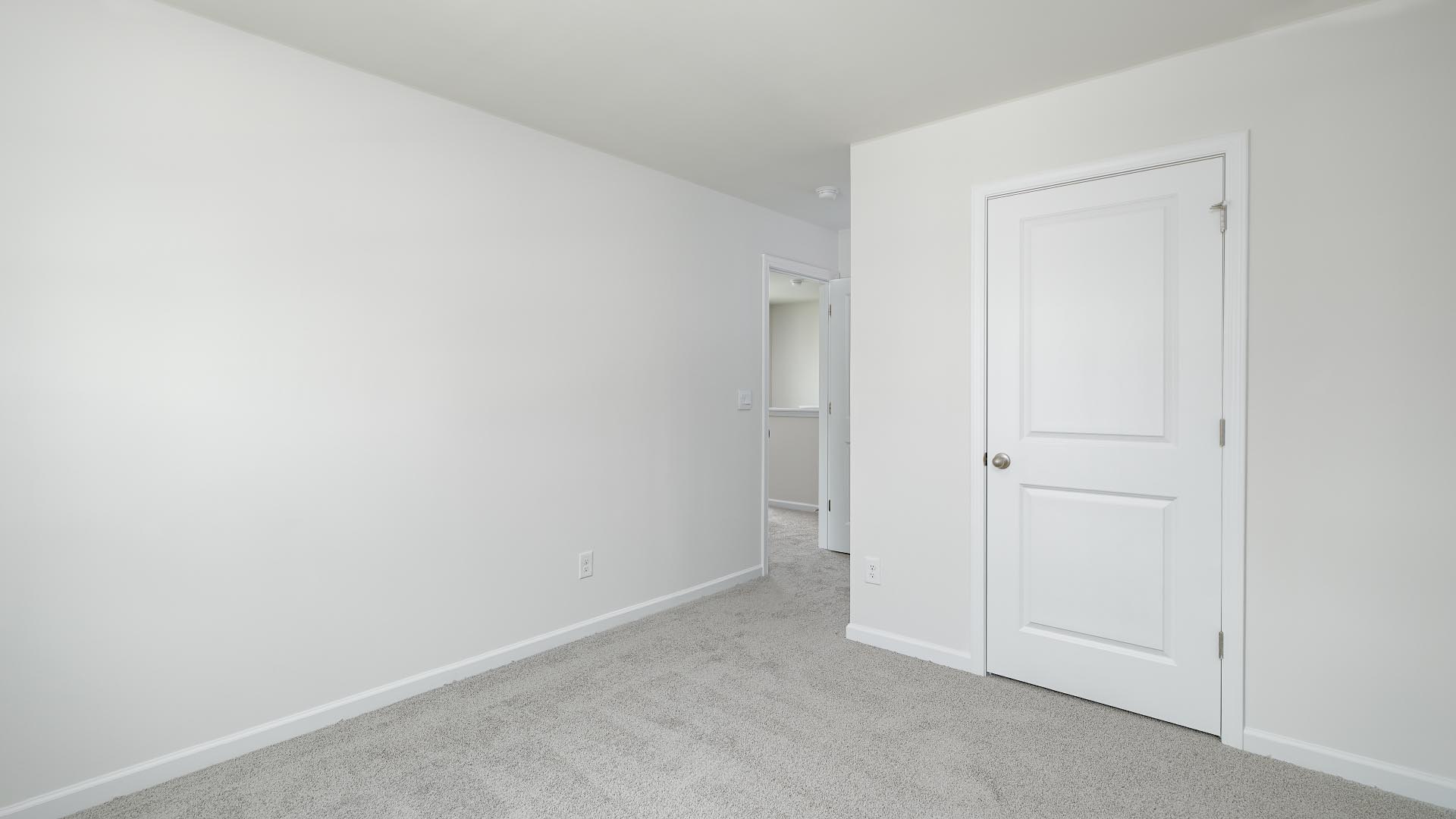 Carpeted bedroom with small window