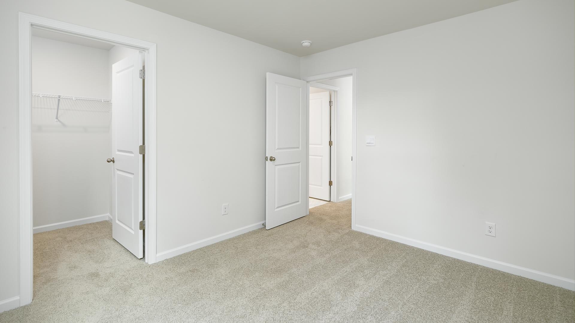 Carpeted bedroom with small window