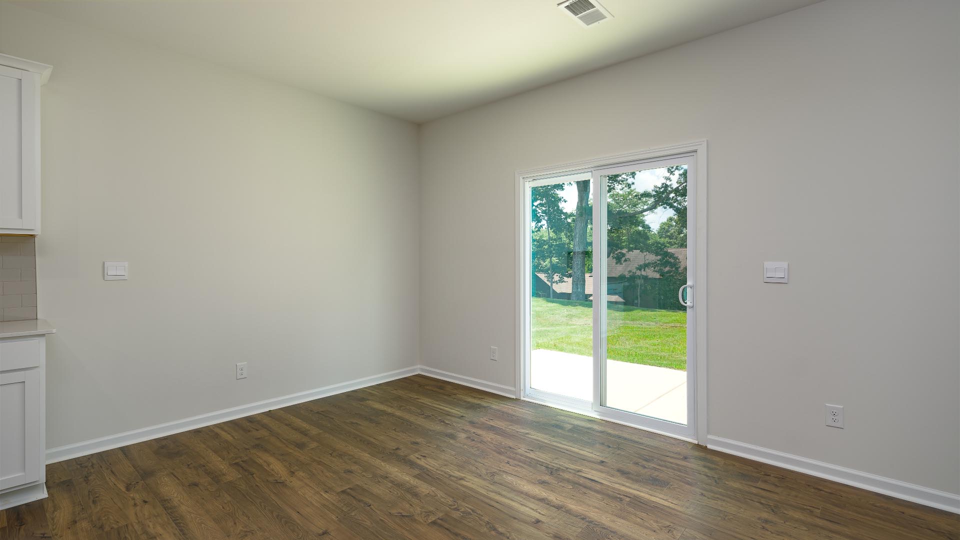 Dining area beside kitchen and sliding glass back door