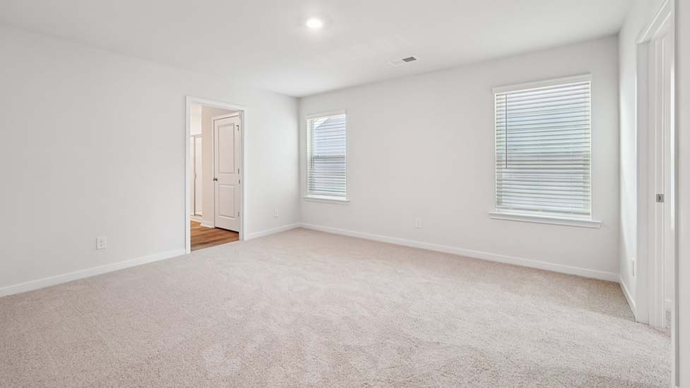 Carpeted bedroom with small window