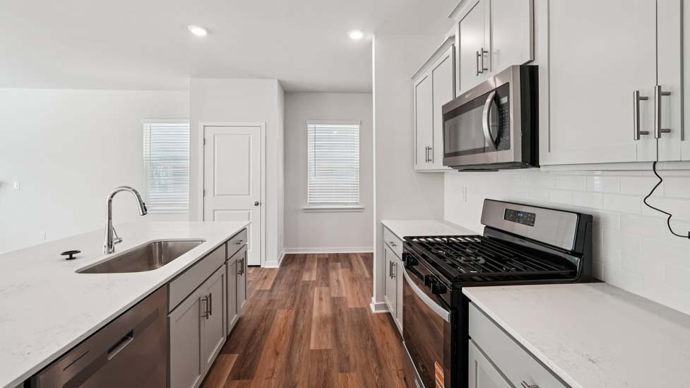 Kitchen and island with stainless steel appliances