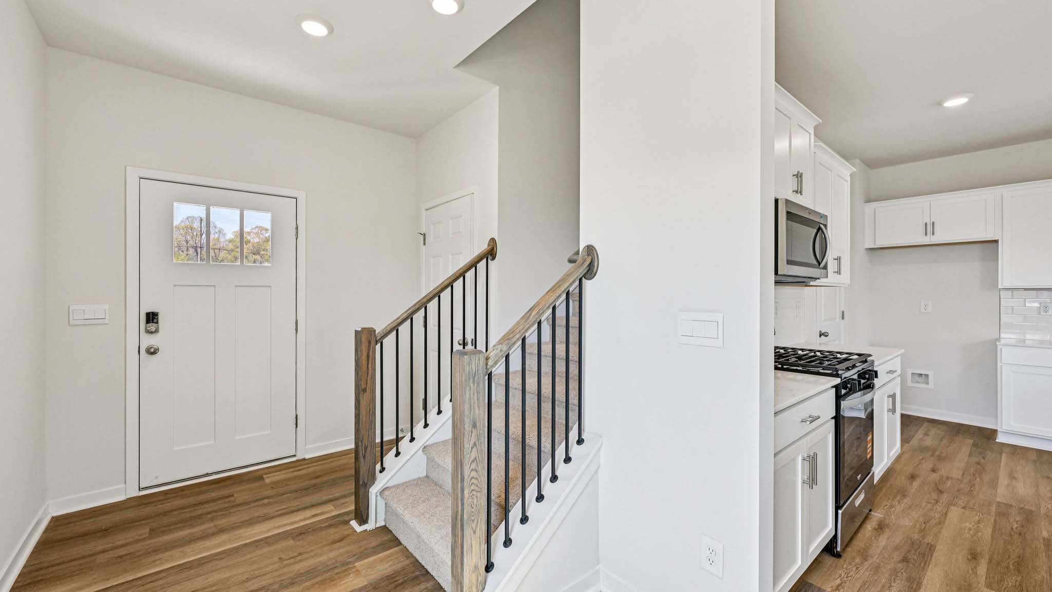 Welcoming foyer with view of front door and stairs