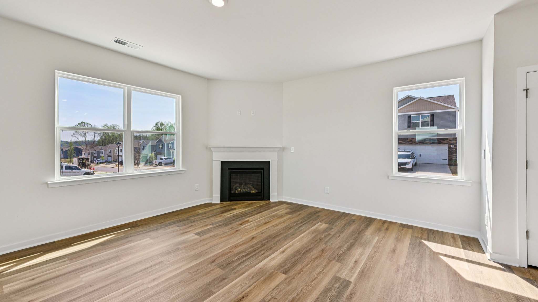 Spacious family room with windows and fireplace