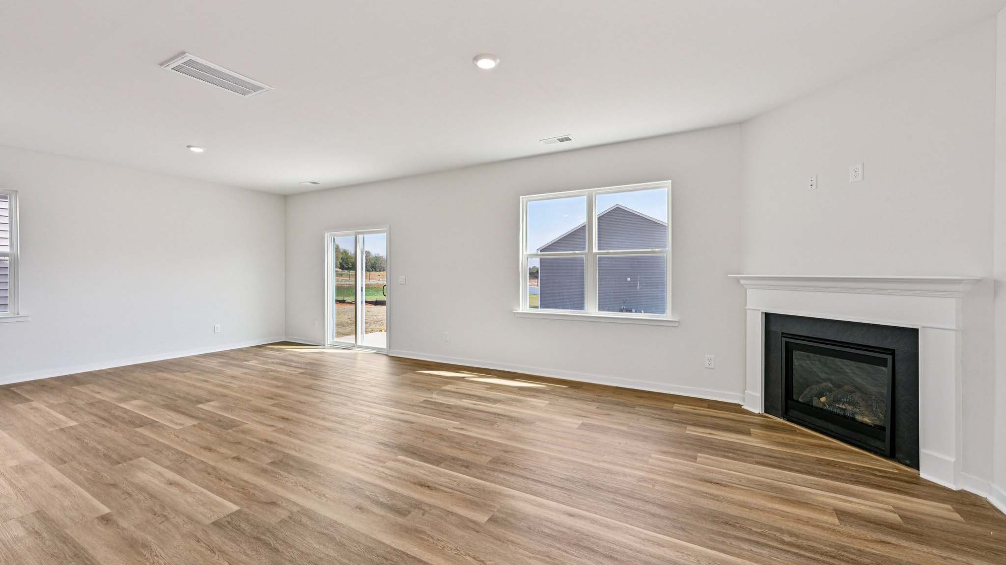 Spacious family room with windows and fireplace