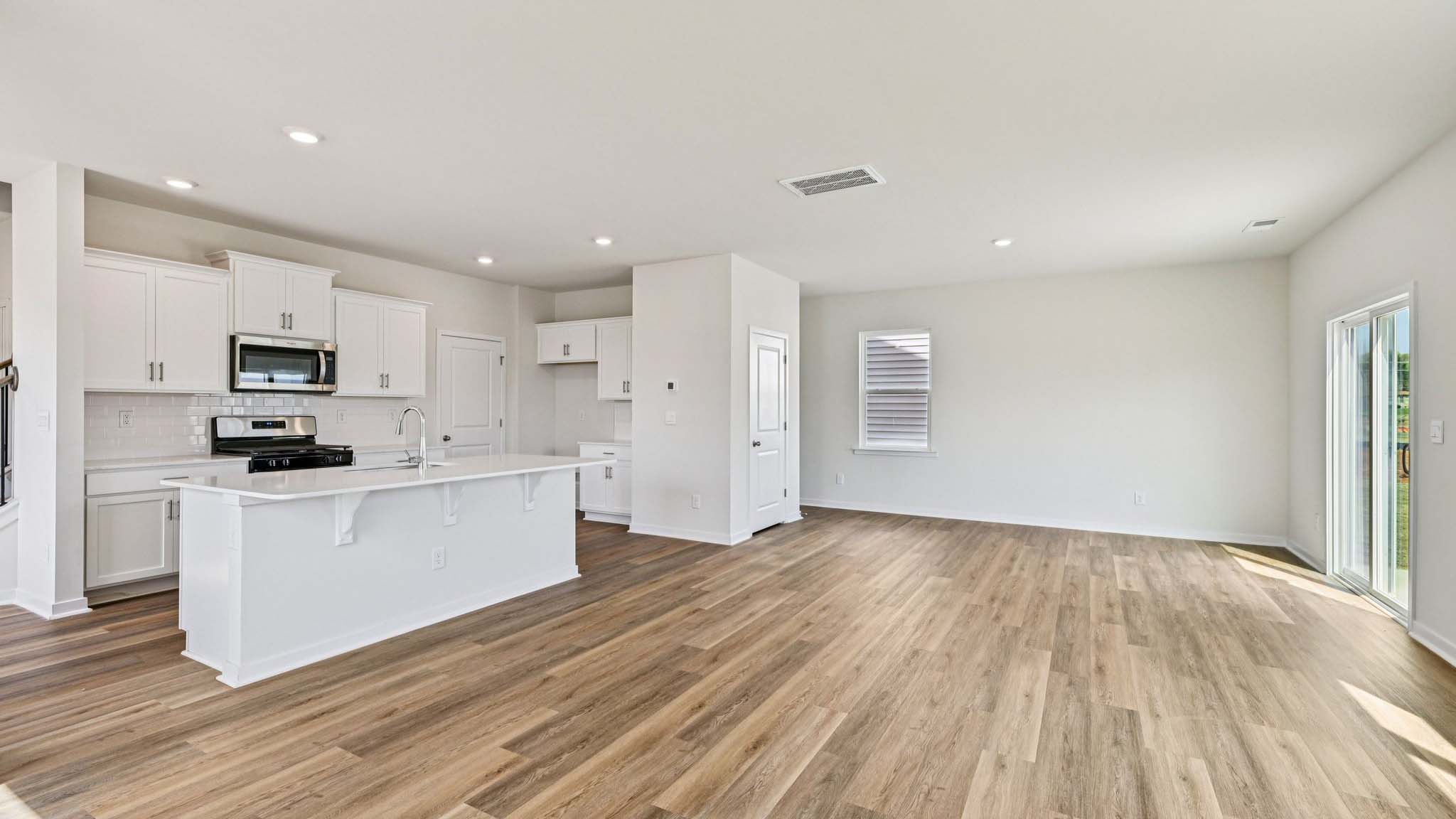 Spacious family room with windows and fireplace