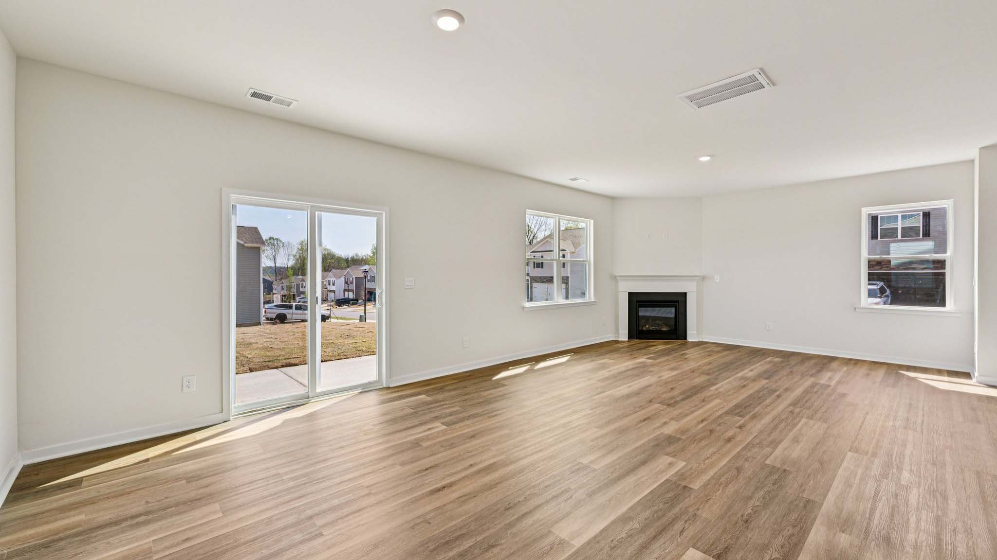 Spacious family room with windows and fireplace