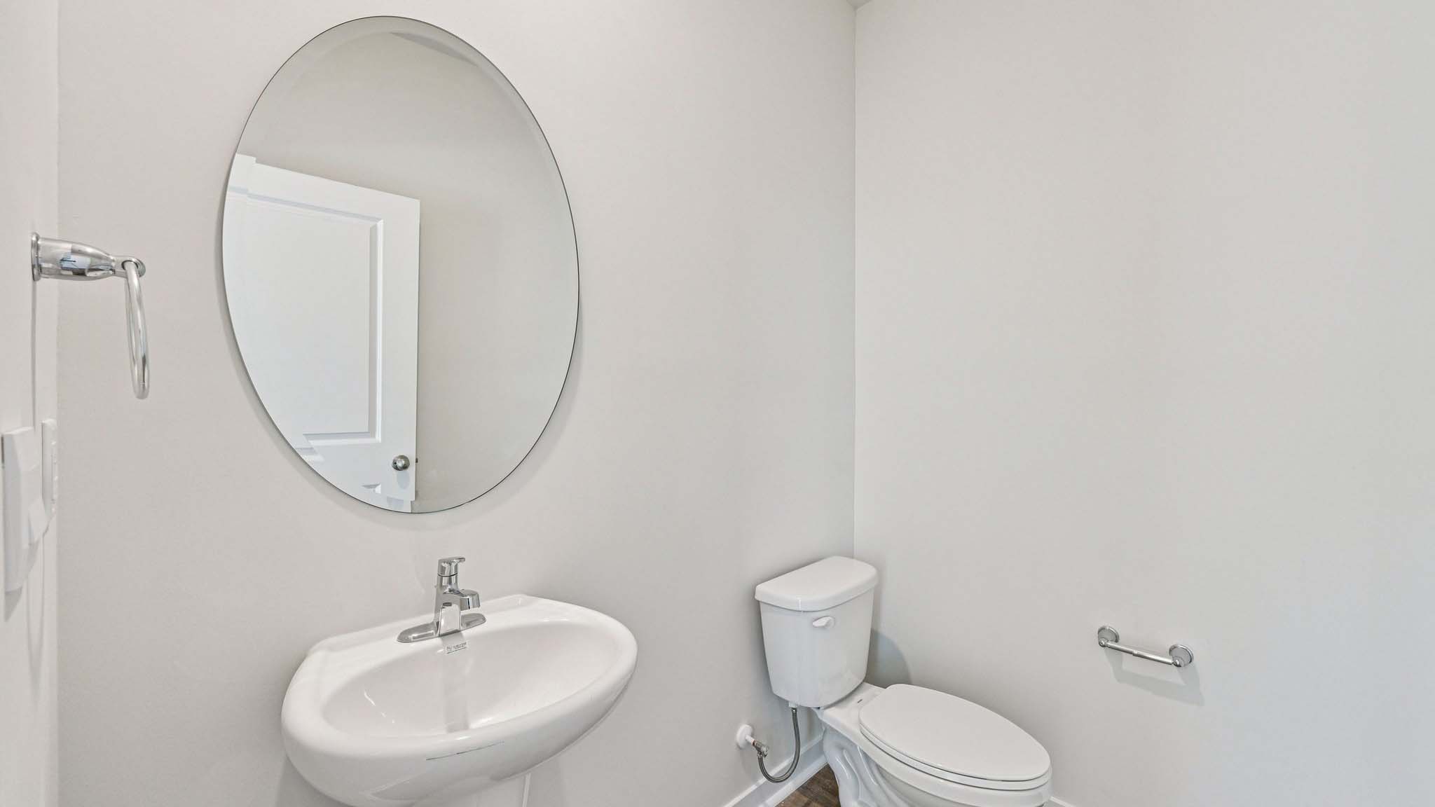 Powder bathroom with small sink and toilet