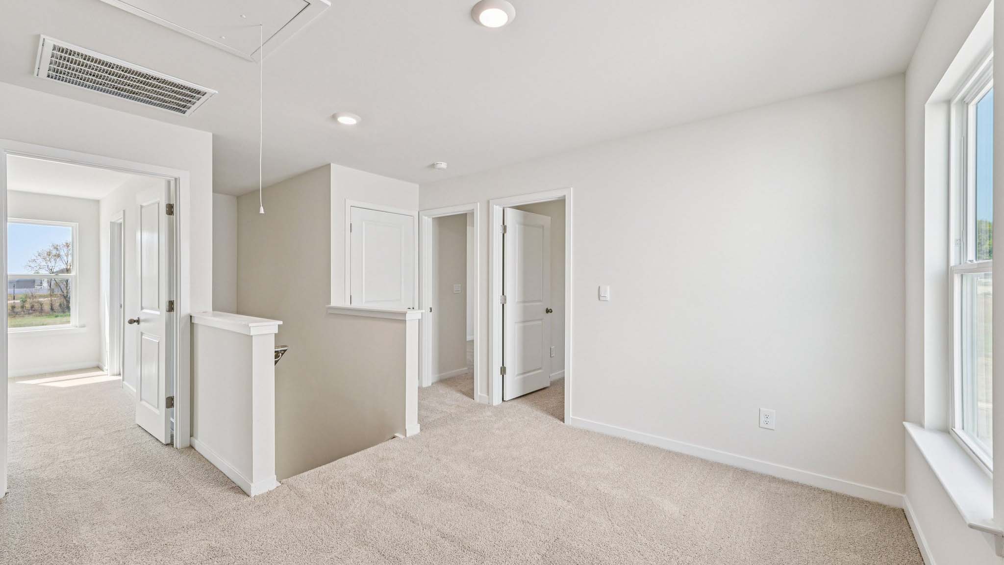 Carpeted loft space atop stairs