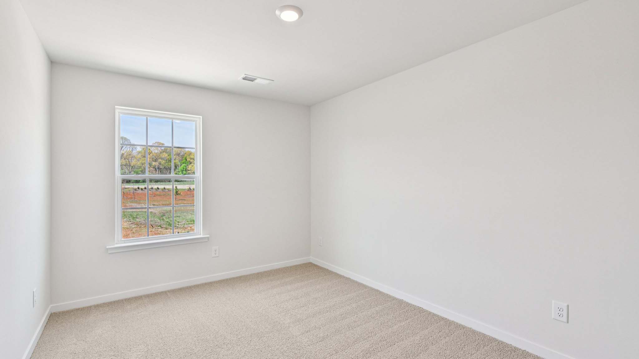 Carpeted bedroom with window