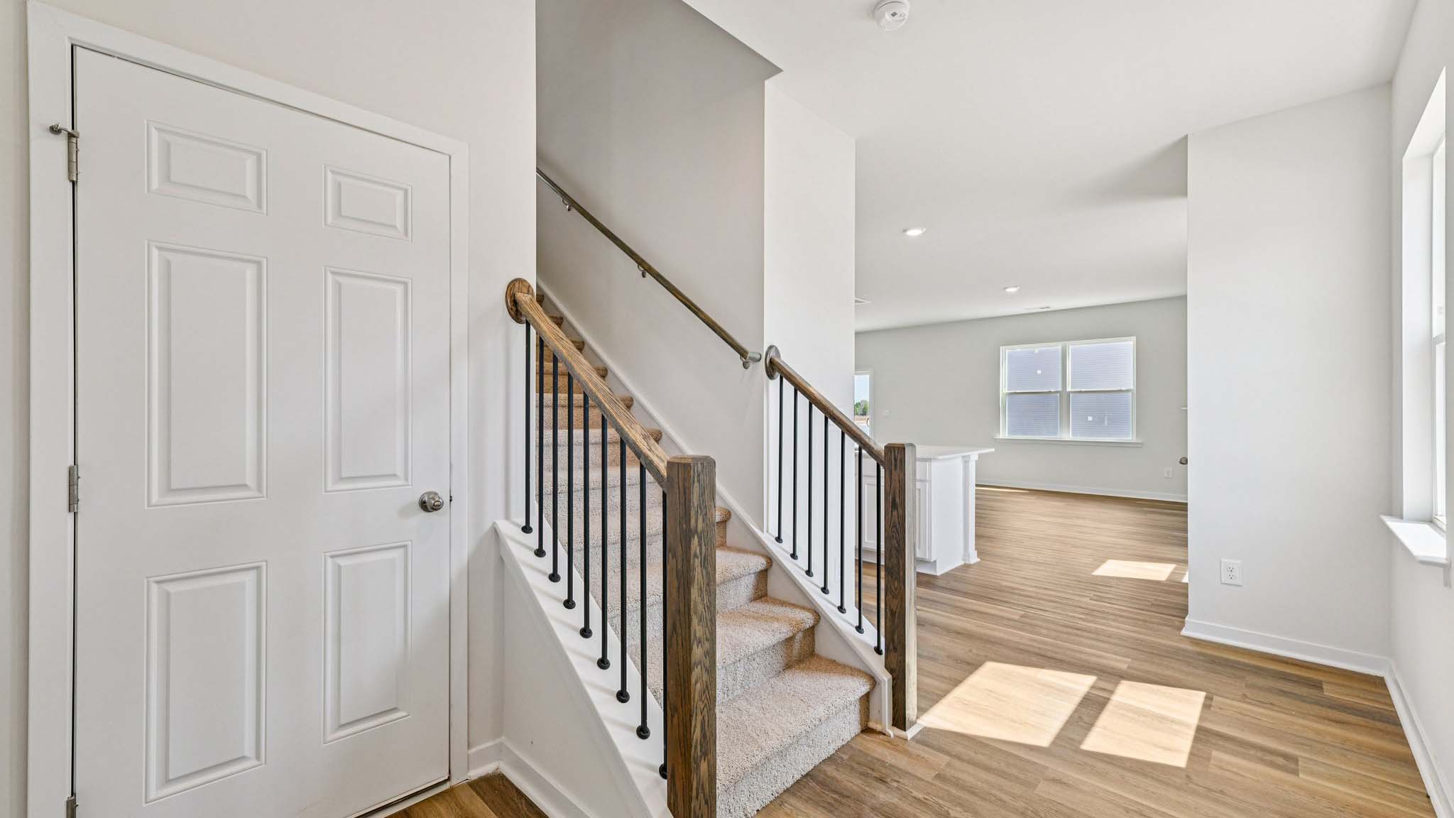 Welcoming foyer with view of front door and stairs