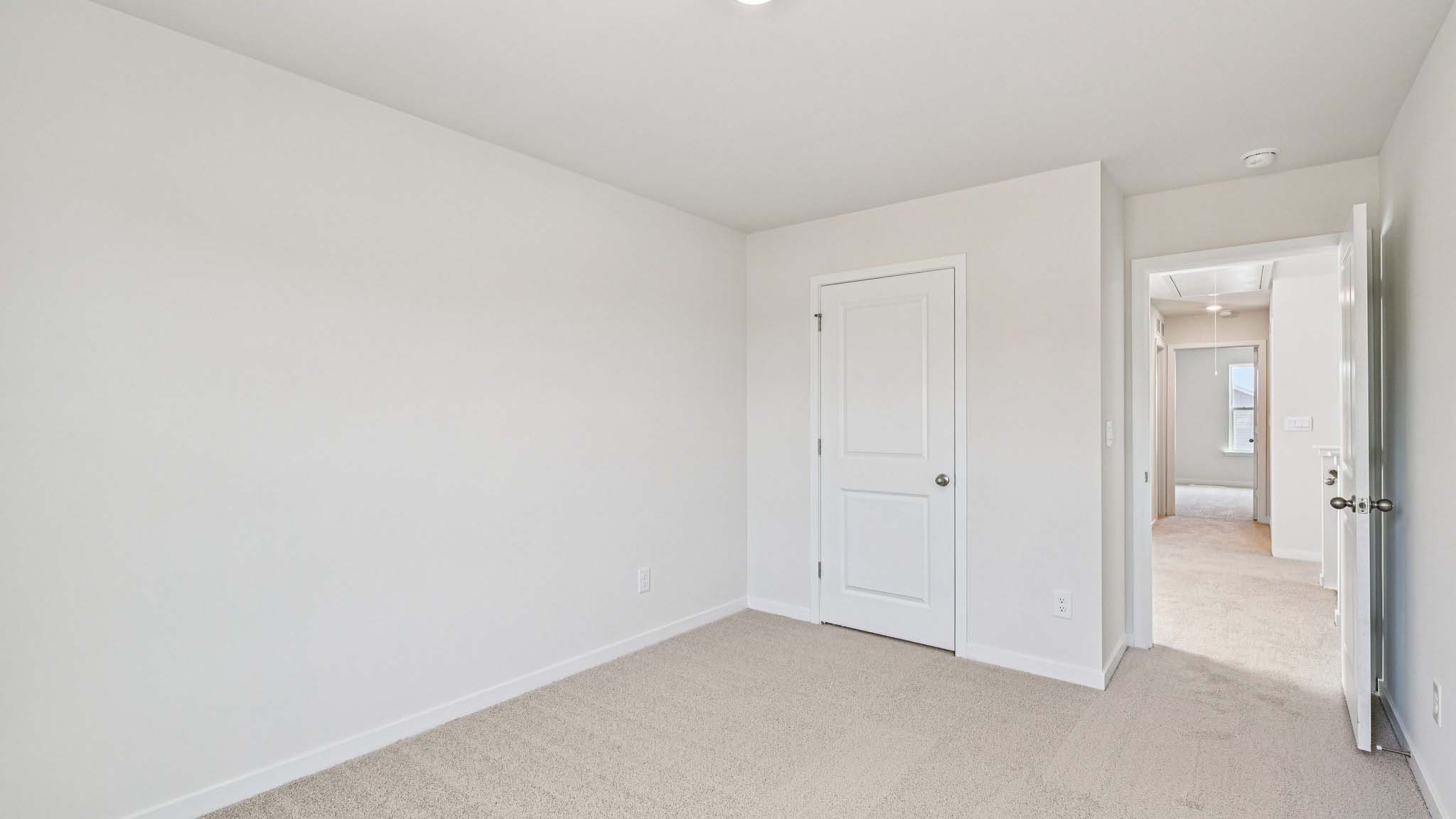 Carpeted bedroom with window