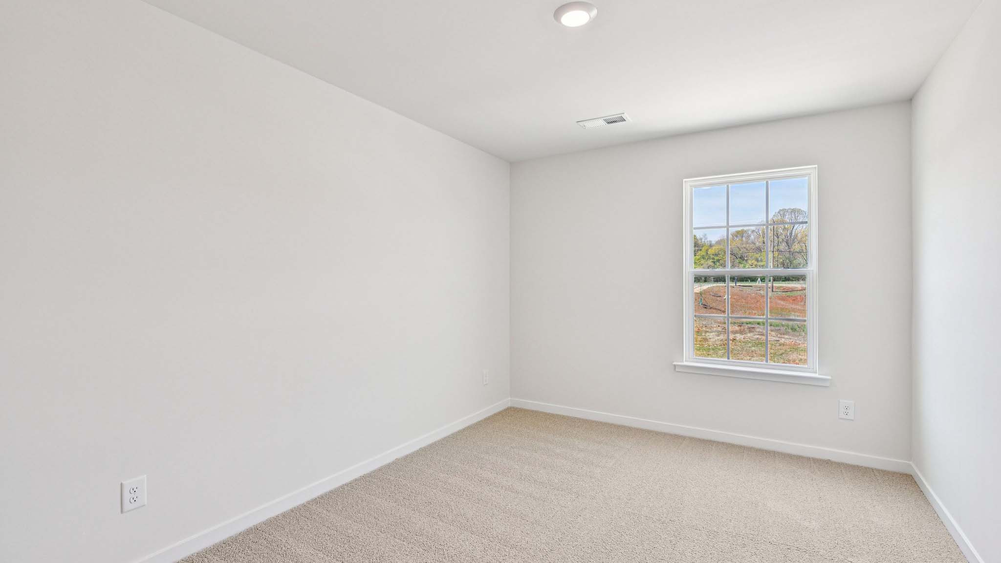 Carpeted bedroom with window